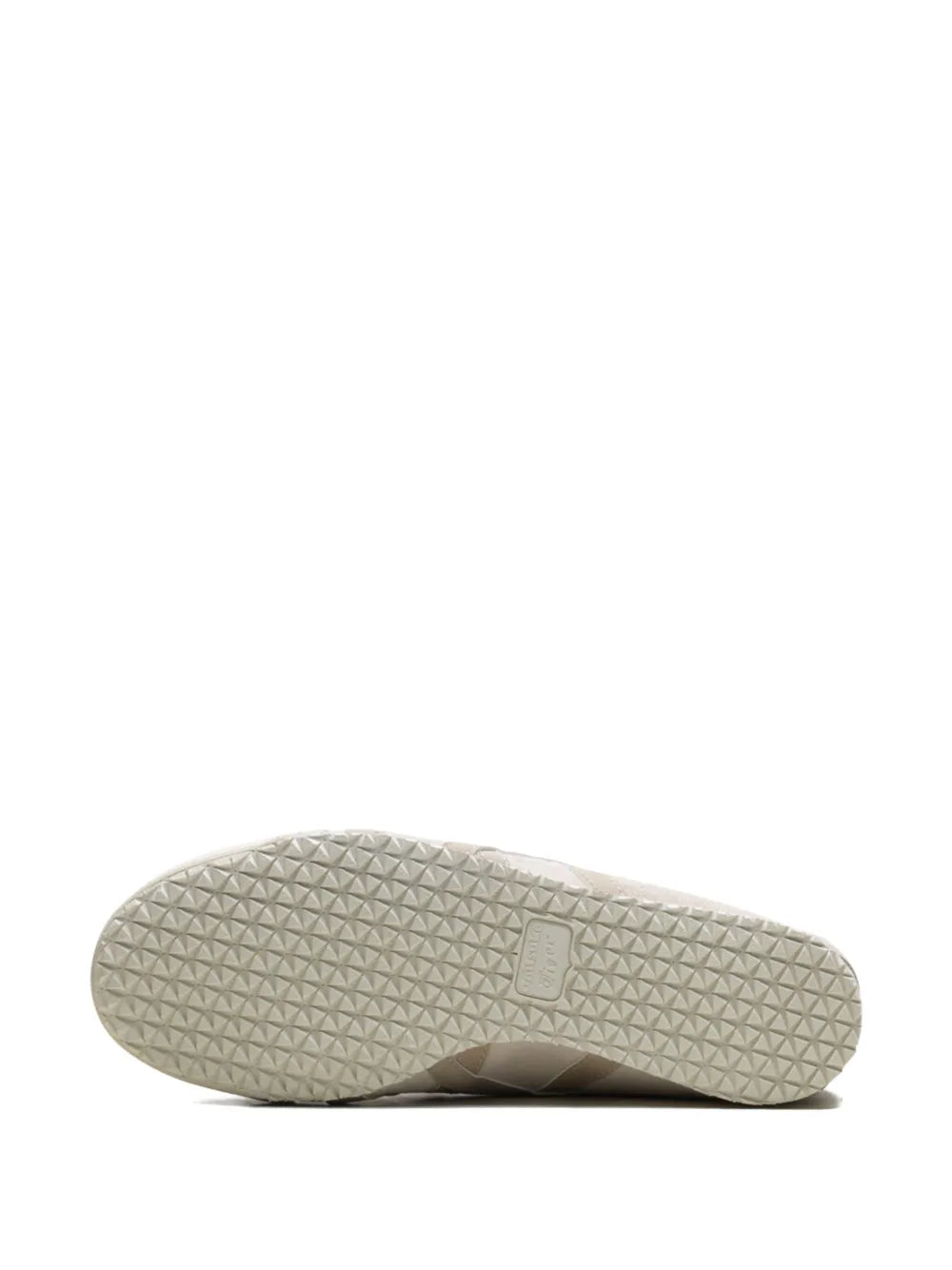 Beige slip-on sneaker outsole with textured tread and small label