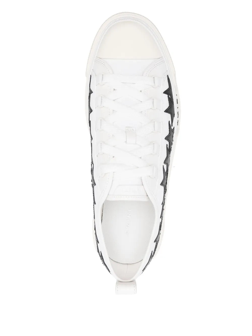 White lace-up sneakers, front view, black star detailing along sides