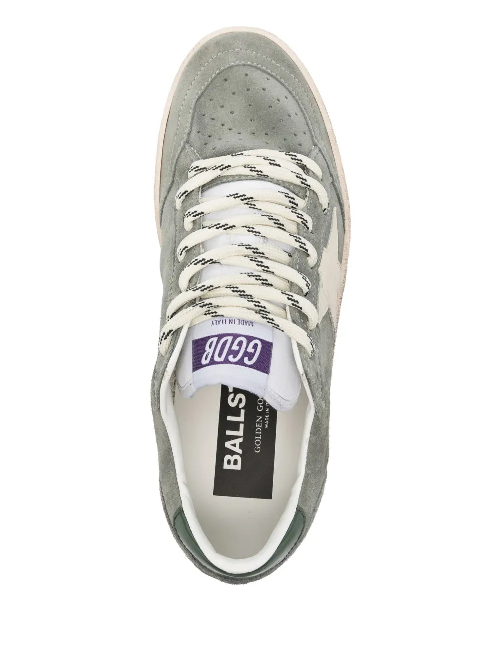 Sage green suede sneaker with white laces and printed tongue label