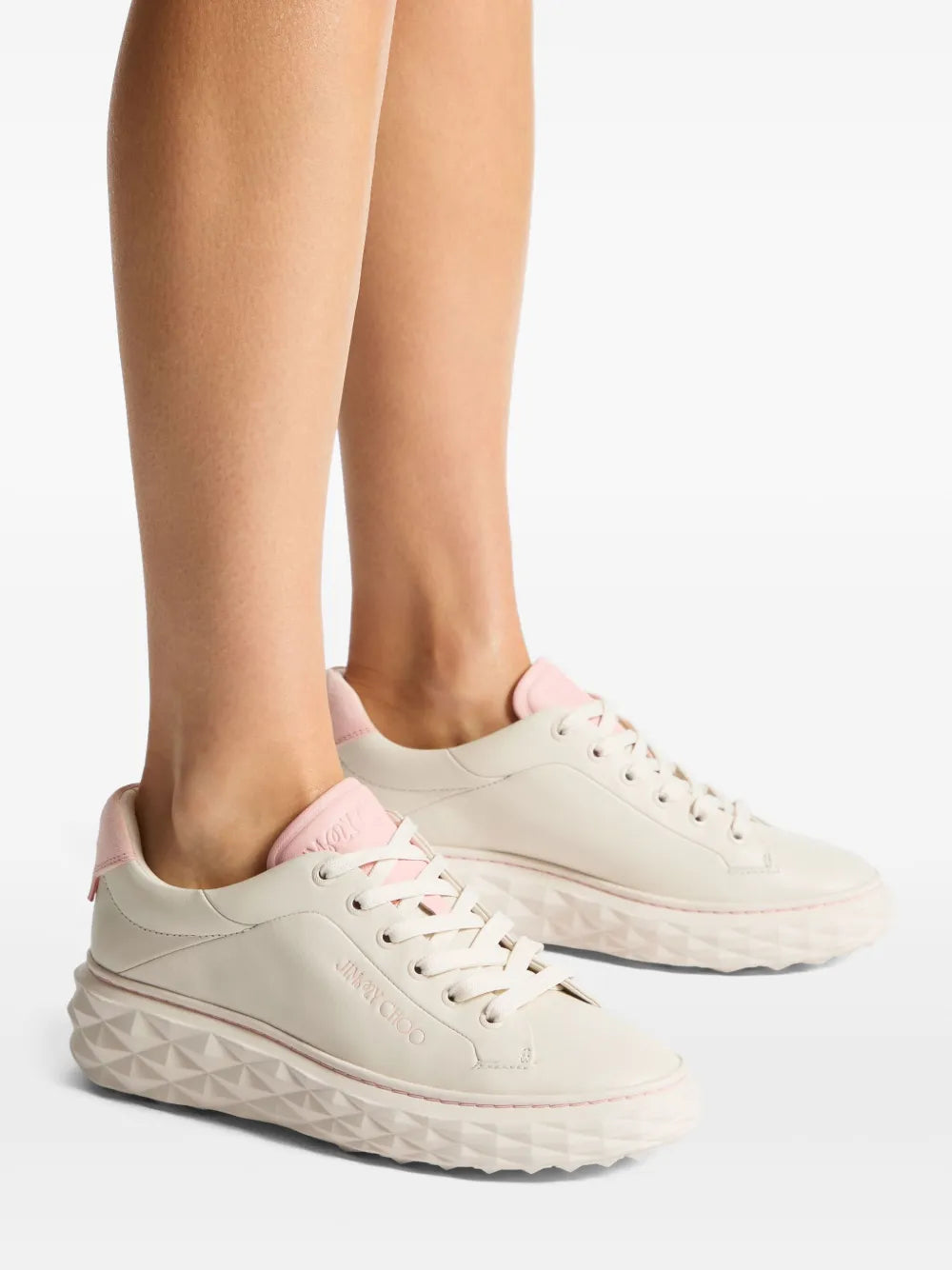 Cream low-top lace-up sneakers with pink accents and textured wedge sole