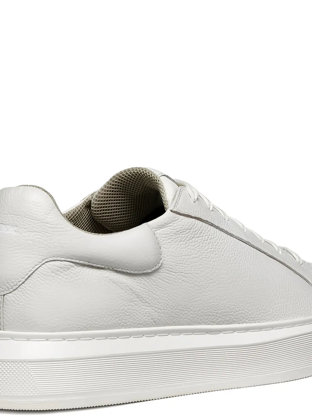 White leather sneaker heel with textured collar lining and grippy ridged sole edge