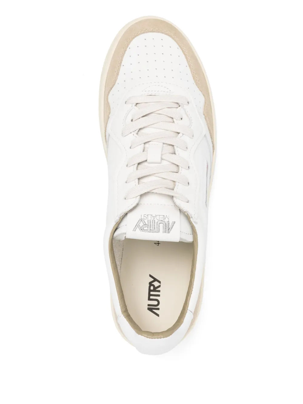 Autry sneaker interior view with white laces and branded insole on beige trim.