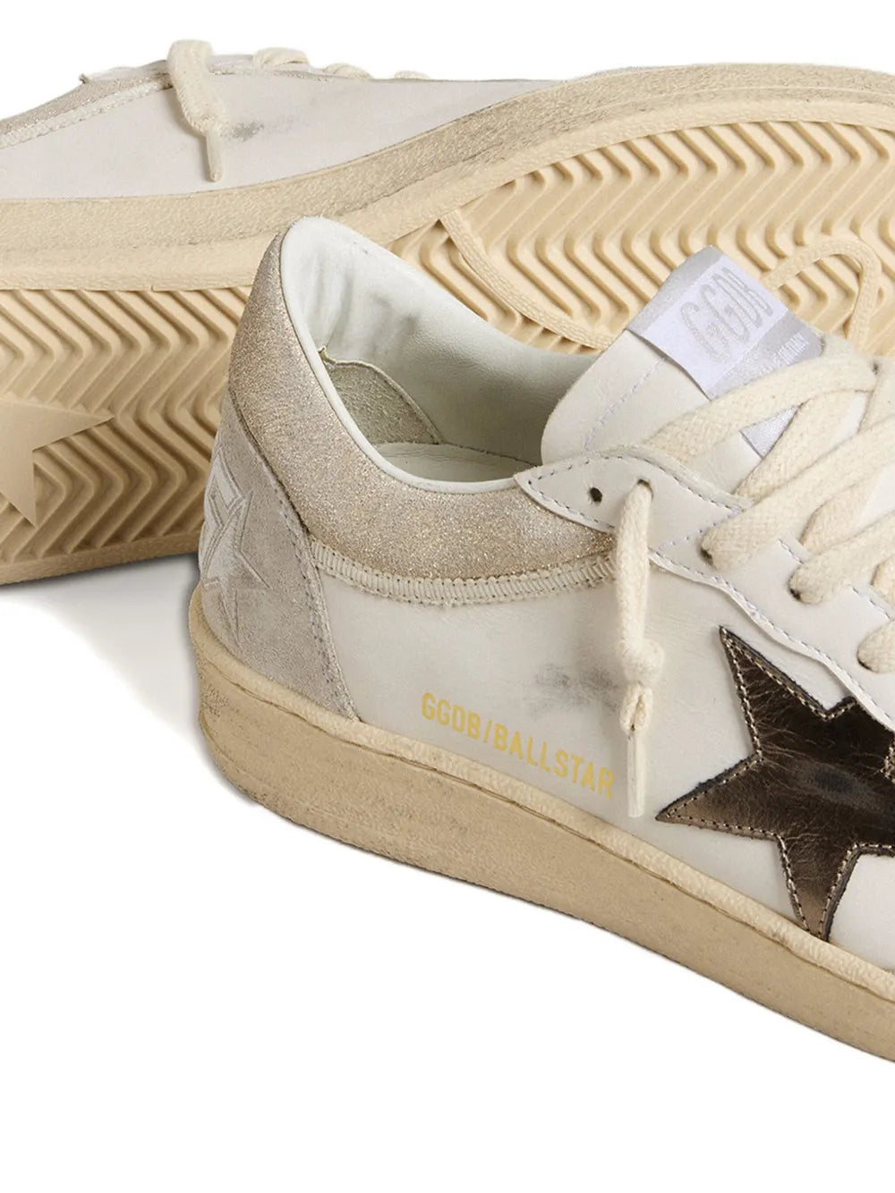 Cream leather sneaker with rubber outsole, lace-up top, and gold side lettering