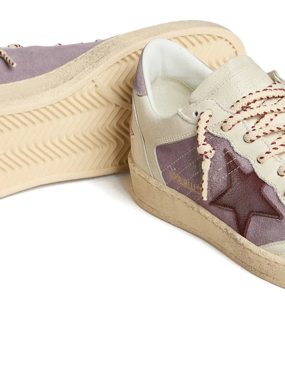 Leather star sneaker close-up with cream lining, lace eyelets, purple star panel