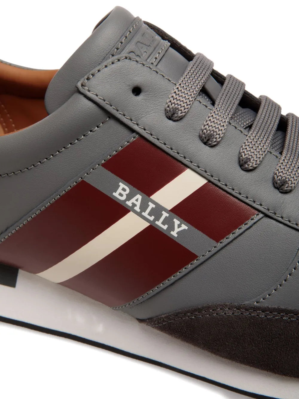 Grey leather sneaker close-up with Bally stripe logo and lace eyelets
