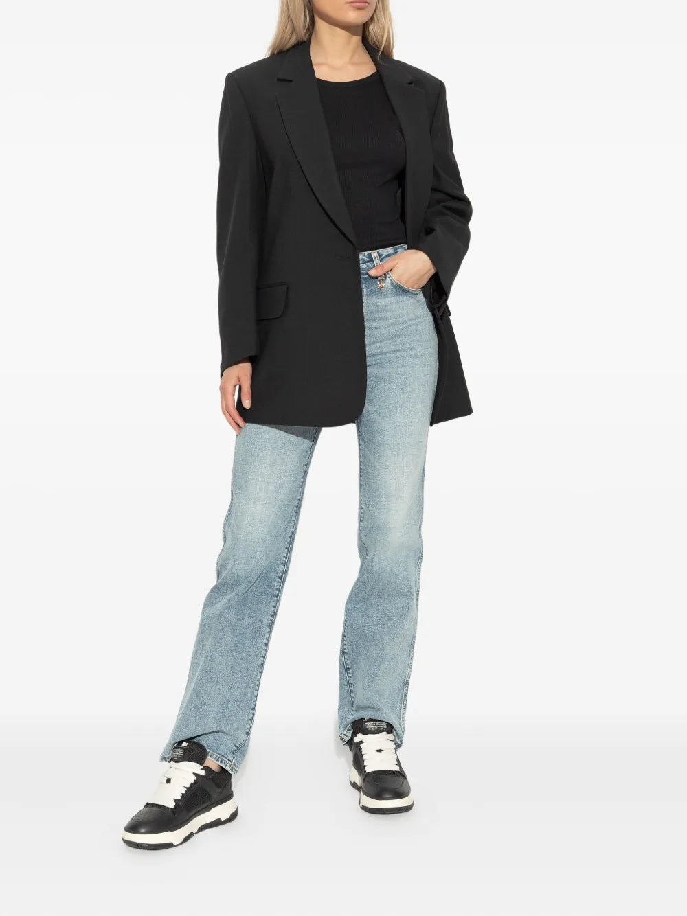 Lace-up mesh sneakers in black and white worn with light-wash jeans