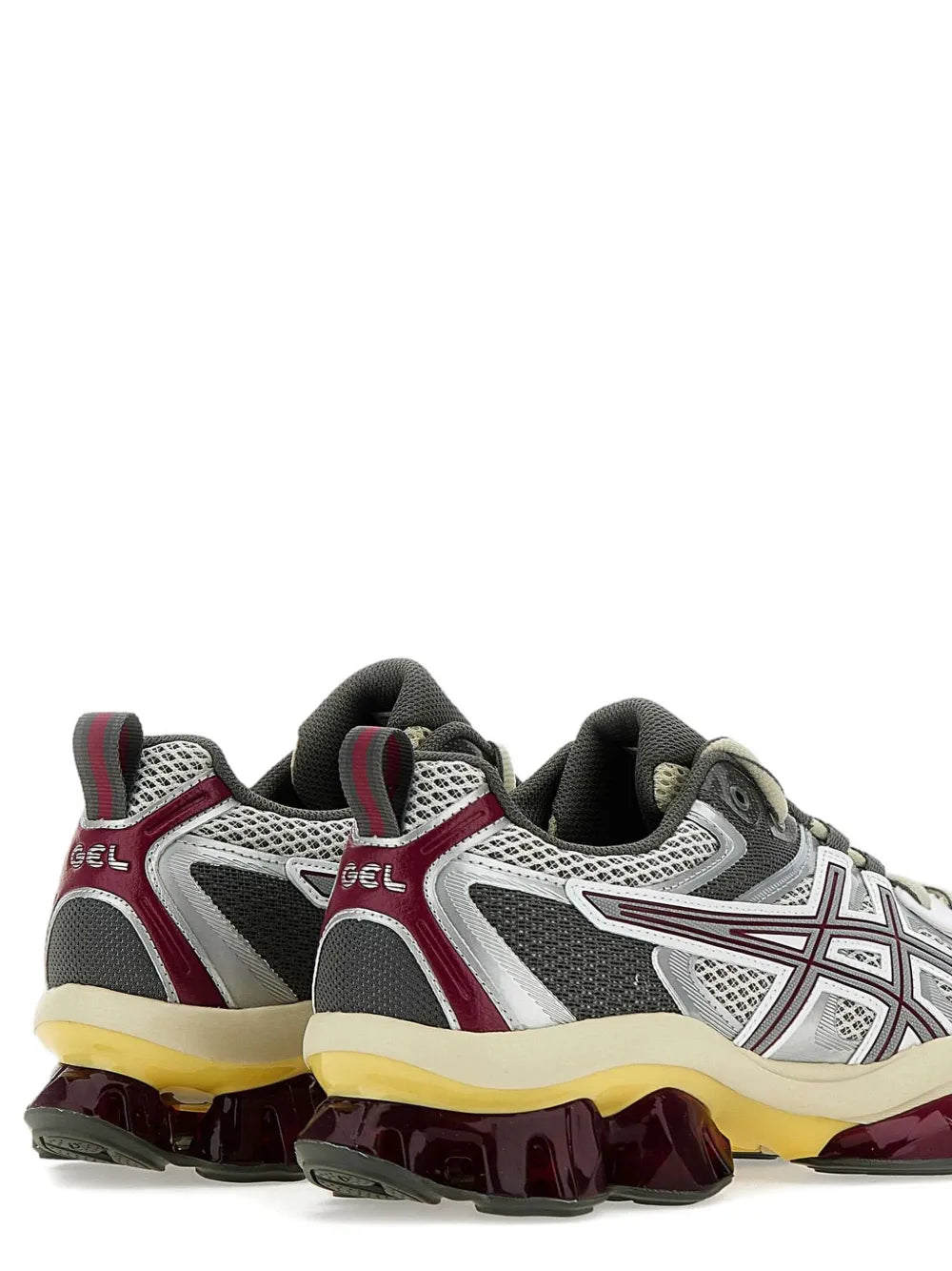 Side view pair of running sneakers with gray mesh, burgundy heel, and yellow outsole