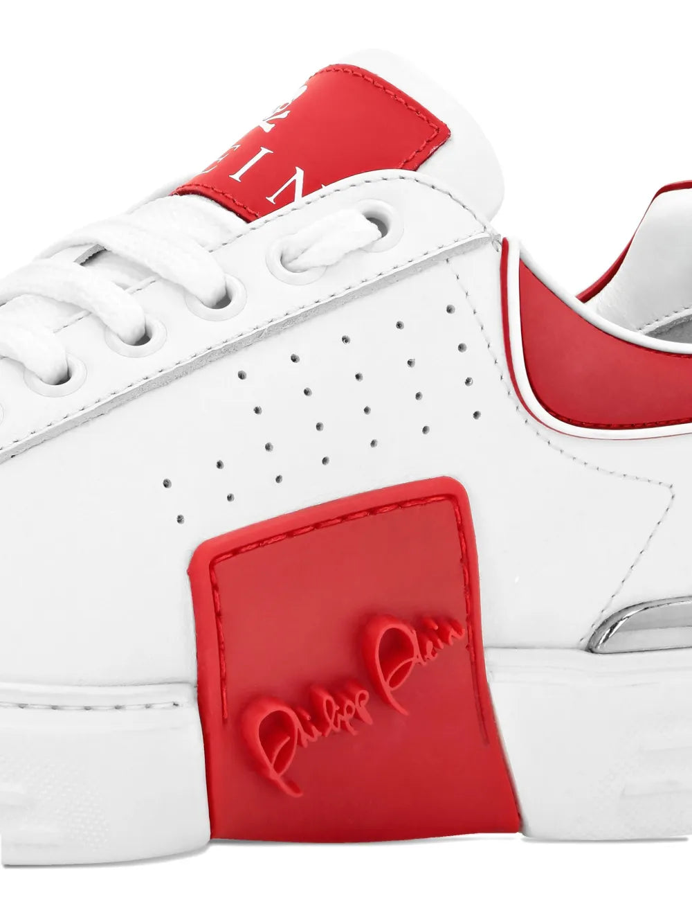 White leather sneakers with red logo-embossed side patch and stitched details