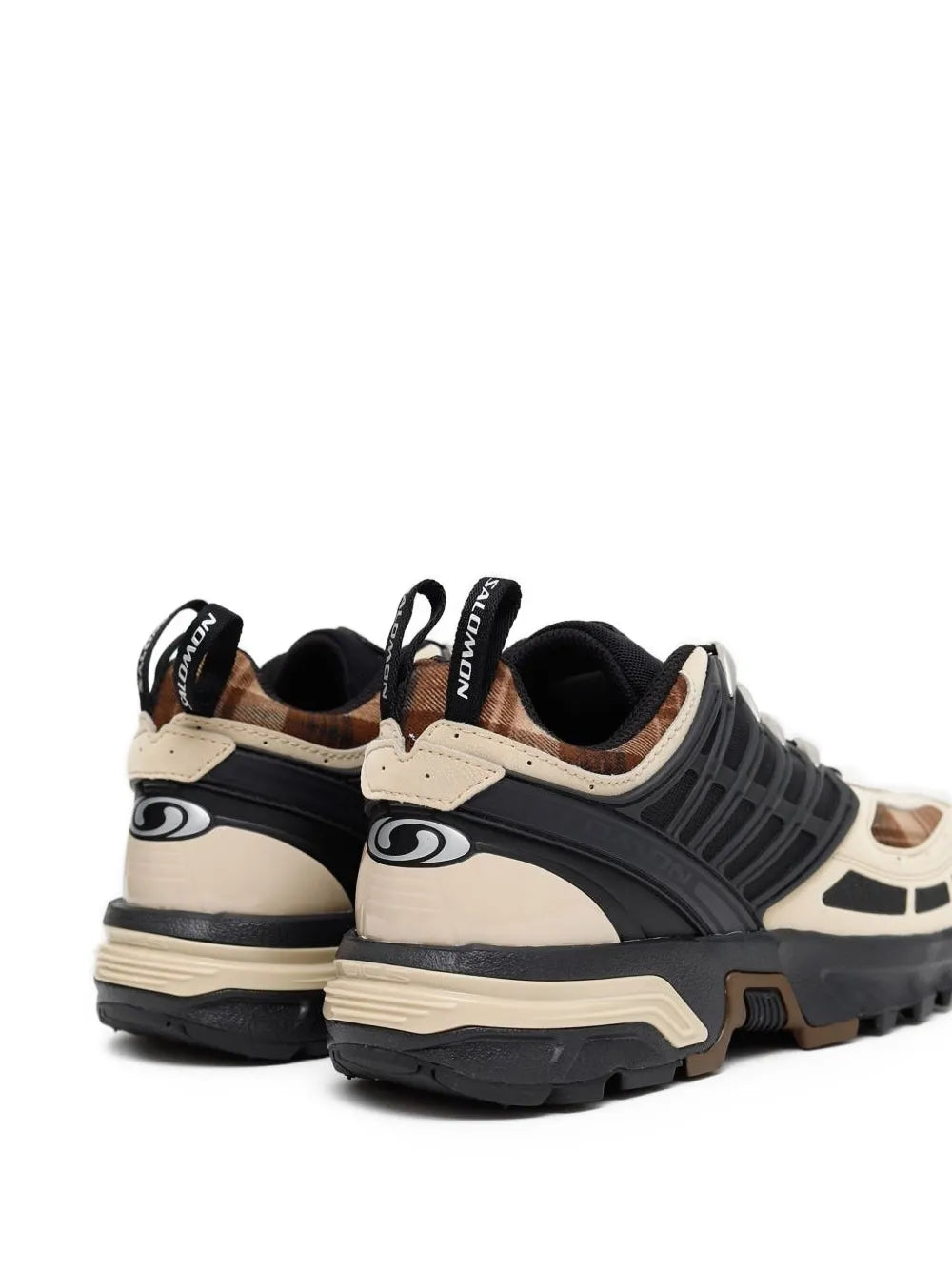 Salomon lace-up sneakers in black and tan with rear pull tabs and rugged outsole