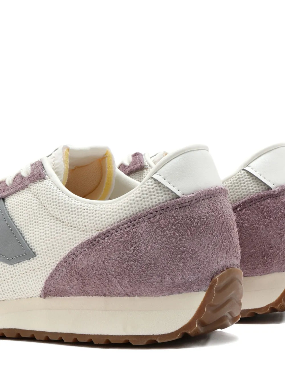 Cream and mauve sneakers with suede heel panel, mesh body, low-profile rubber sole.