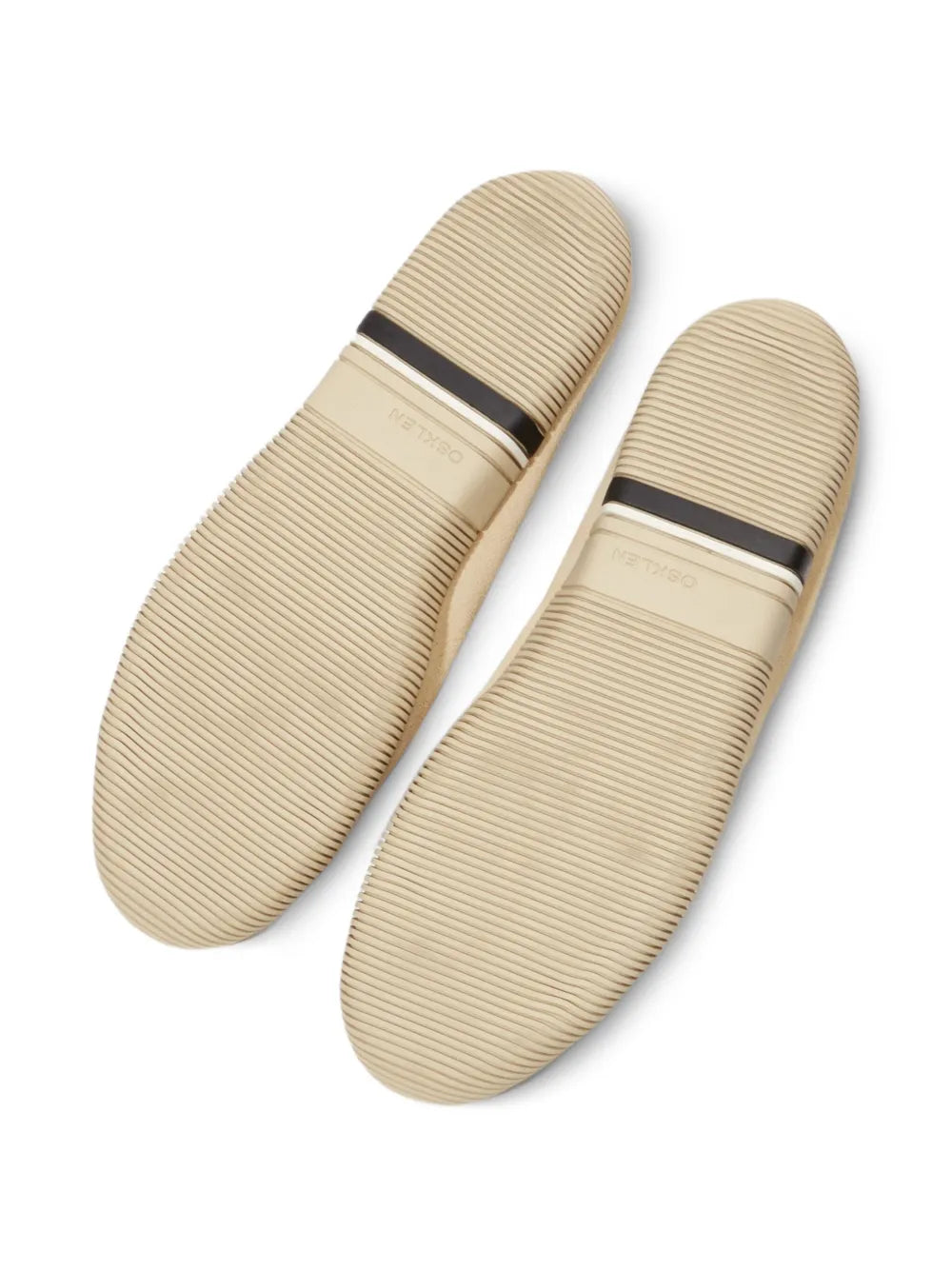 Beige suede sneakers soles with textured tread and dark heel stripe