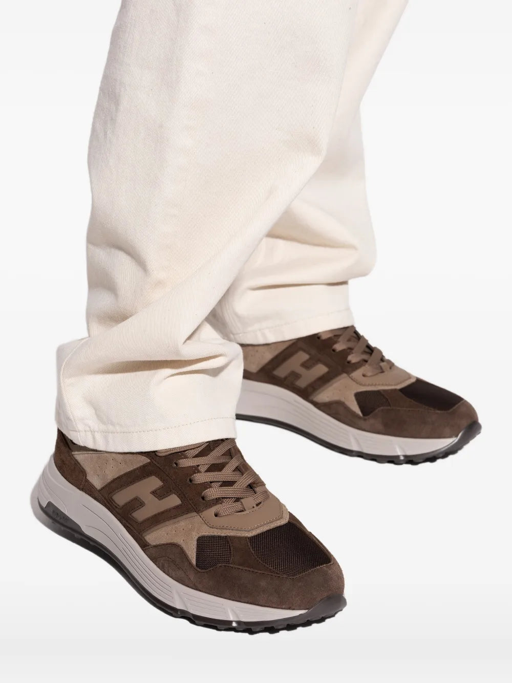 Brown suede-leather sneaker pair with lace-up, side panels, and chunky sole