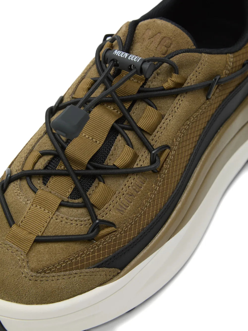 Close-up of khaki green lace-up sneakers with black laces and padded white sole
