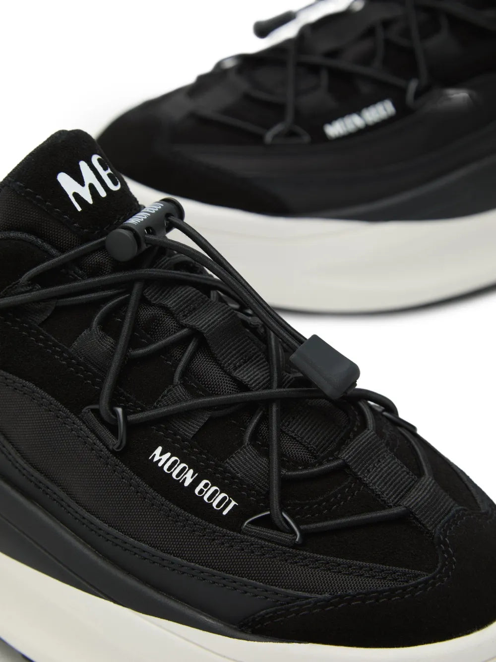 Black mesh platform sneakers close-up, Moon Boot logo on lace panel