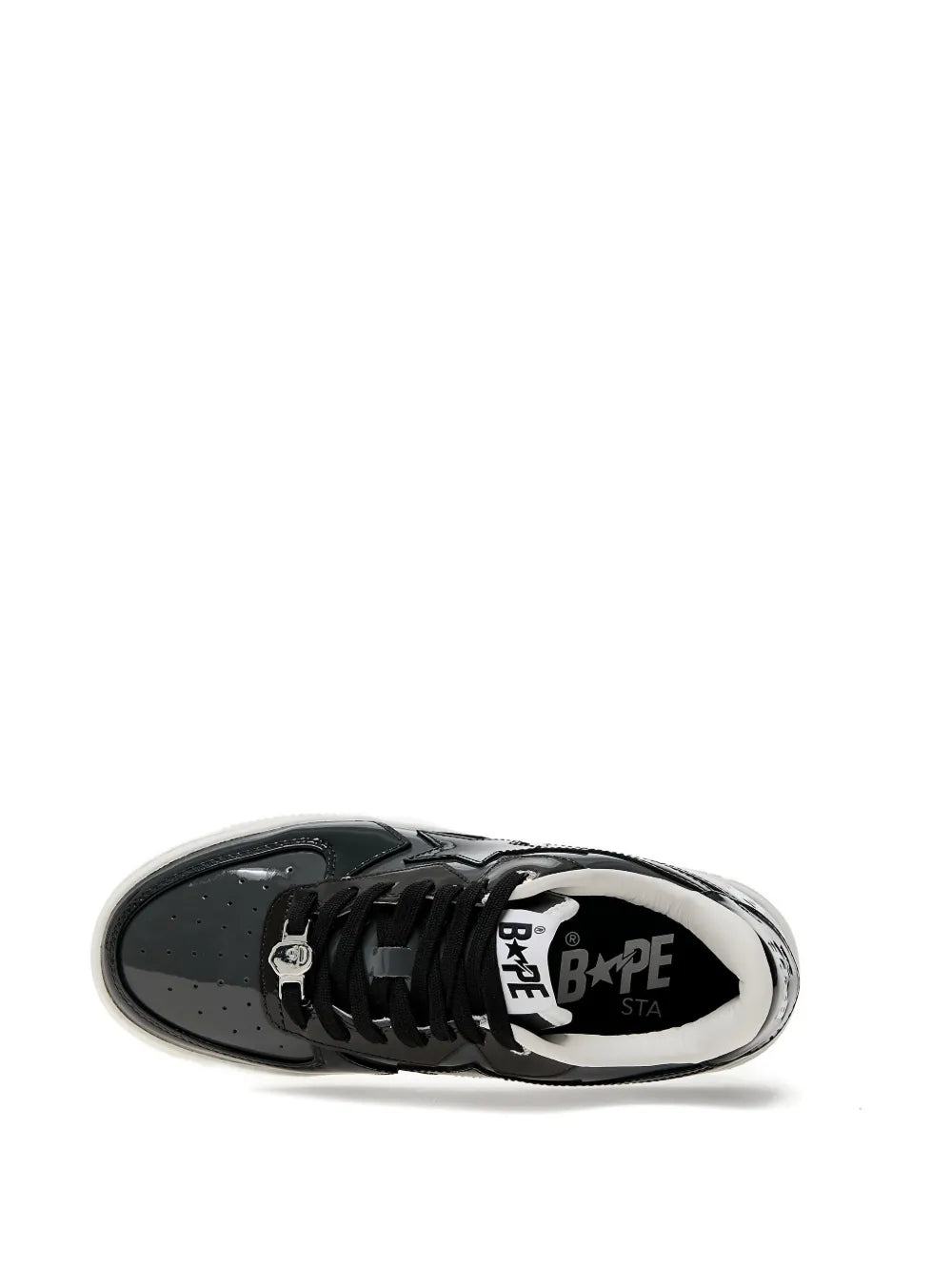 Black patent leather low-top sneaker close-up of toe and lace panel with logos