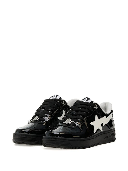 Black low-top sneakers with white star logo, BAPE STA side text, lace-up