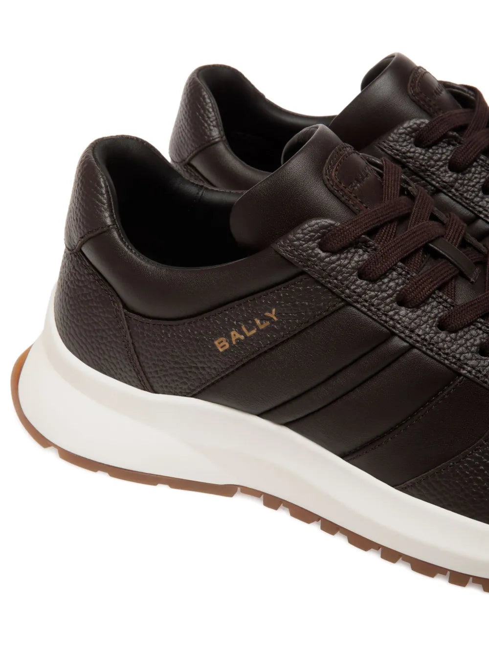 Brown sneakers with Bally logo, dark laces, textured panels, and white midsole.
