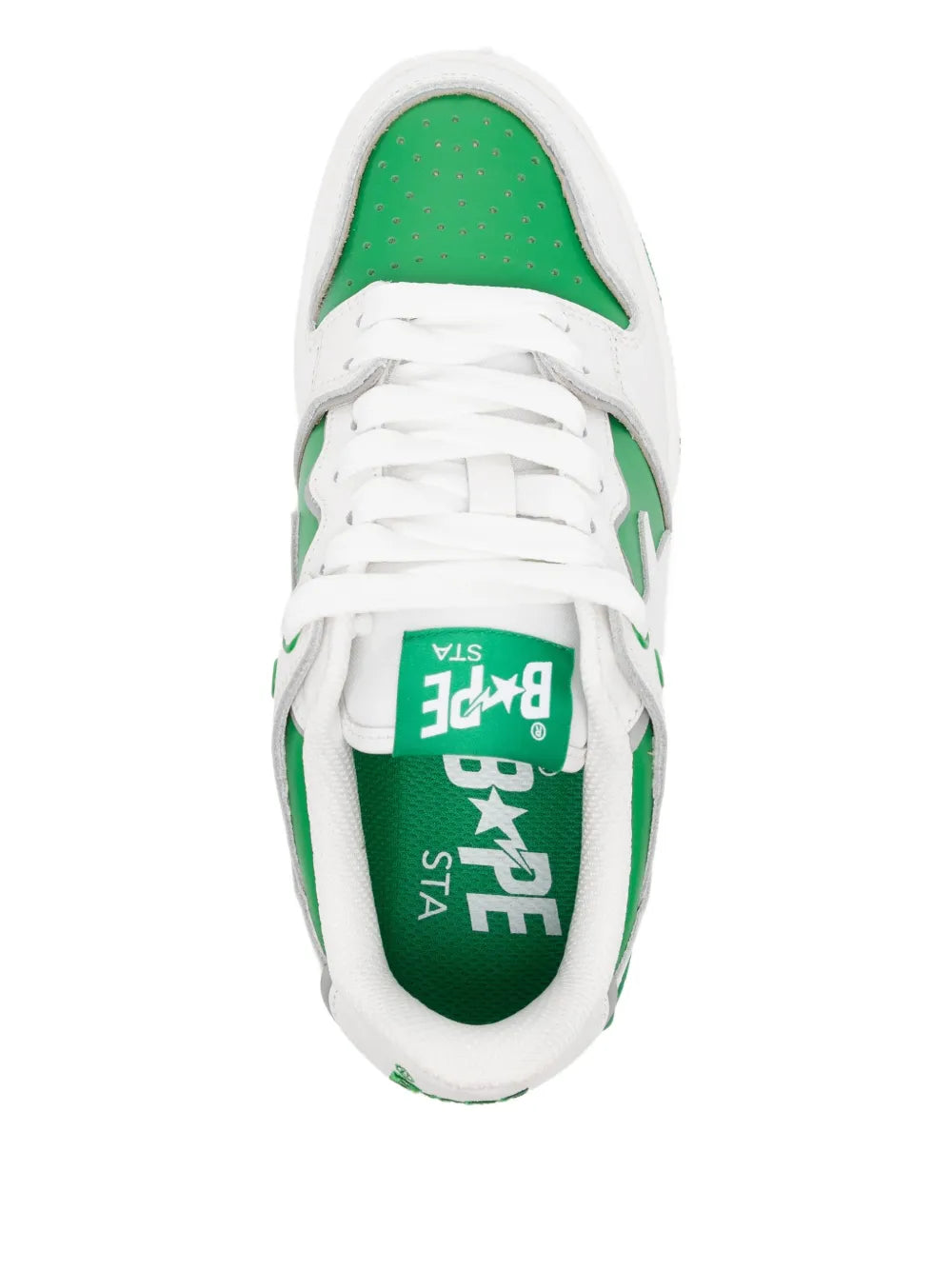 White sneaker interior with green insole logo and star print under laces