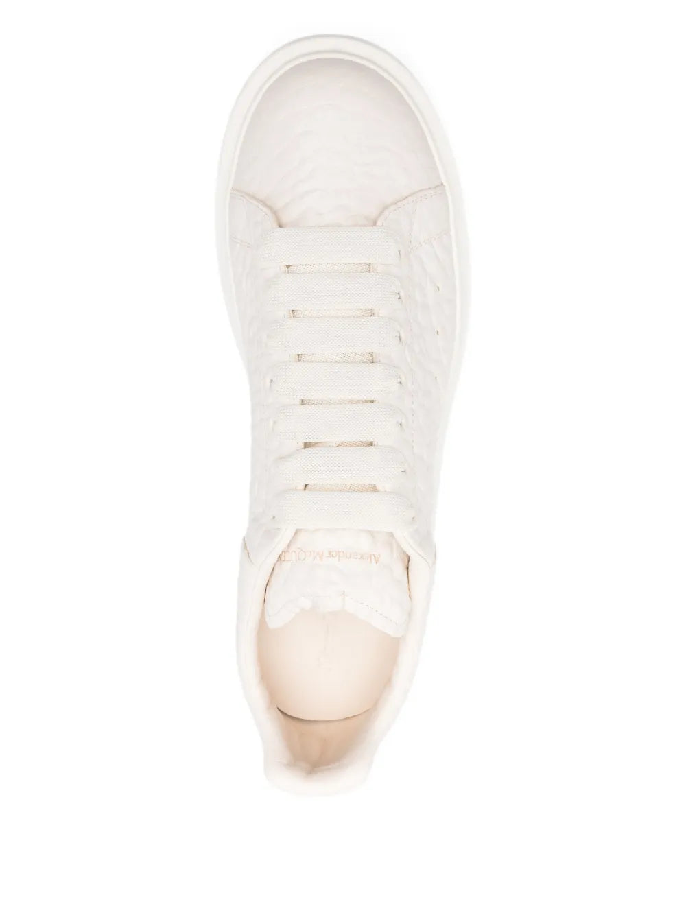Off-white lace-up sneakers with textured upper and round toe