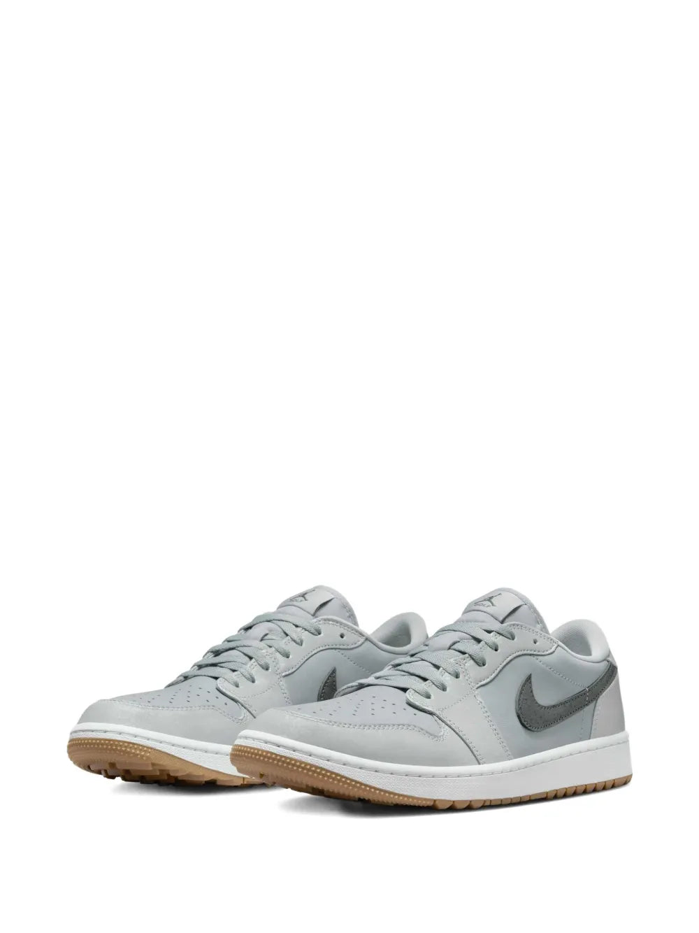 Pair of grey lace-up golf sneakers with Nike Swoosh and gum outsole detail.