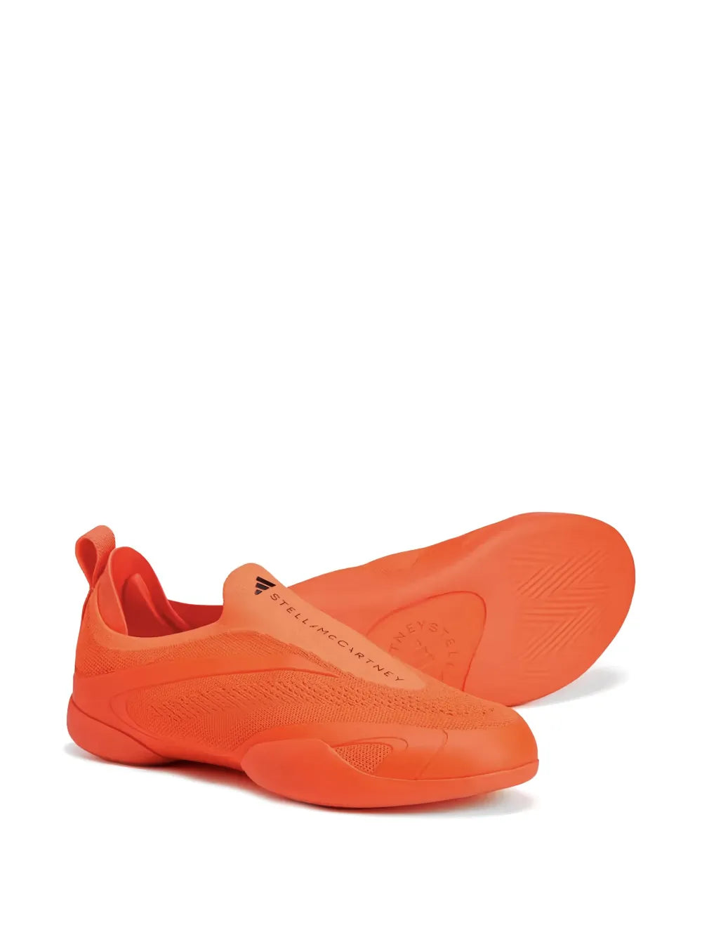 Orange slip-on taekwondo sneakers by adidas by Stella McCartney, outsole view