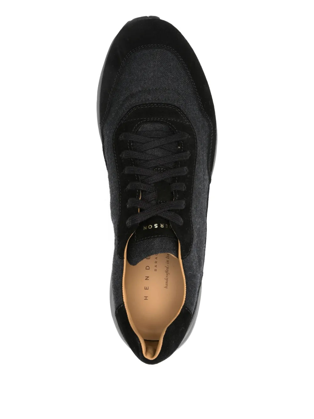 Black lace-up sneaker interior view with tan insole and black padded lining