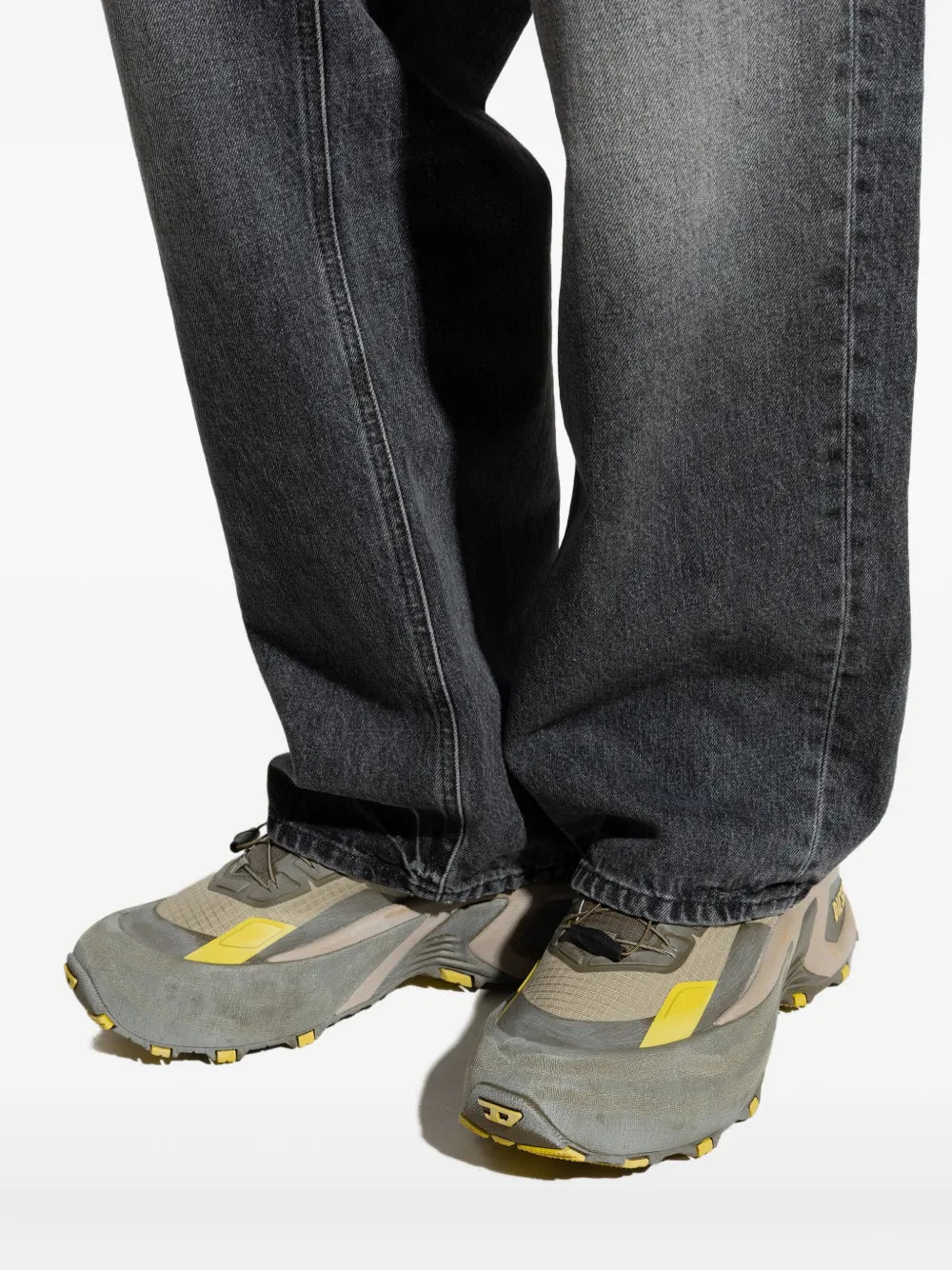 Diesel grey chunky lace-up runner sneakers worn with dark blue jeans