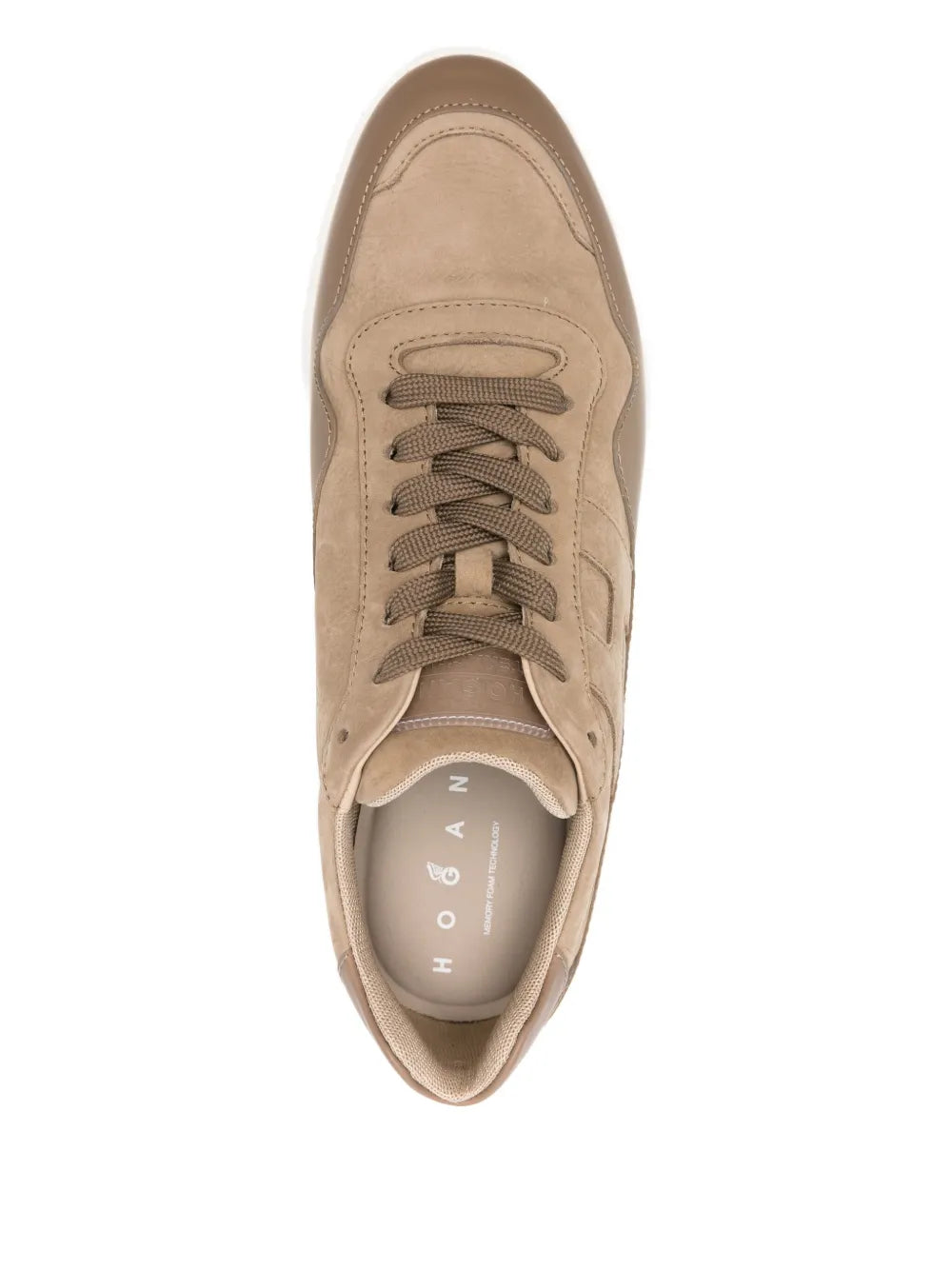 Beige leather lace-up sneakers close-up, padded tongue and lace eyelets