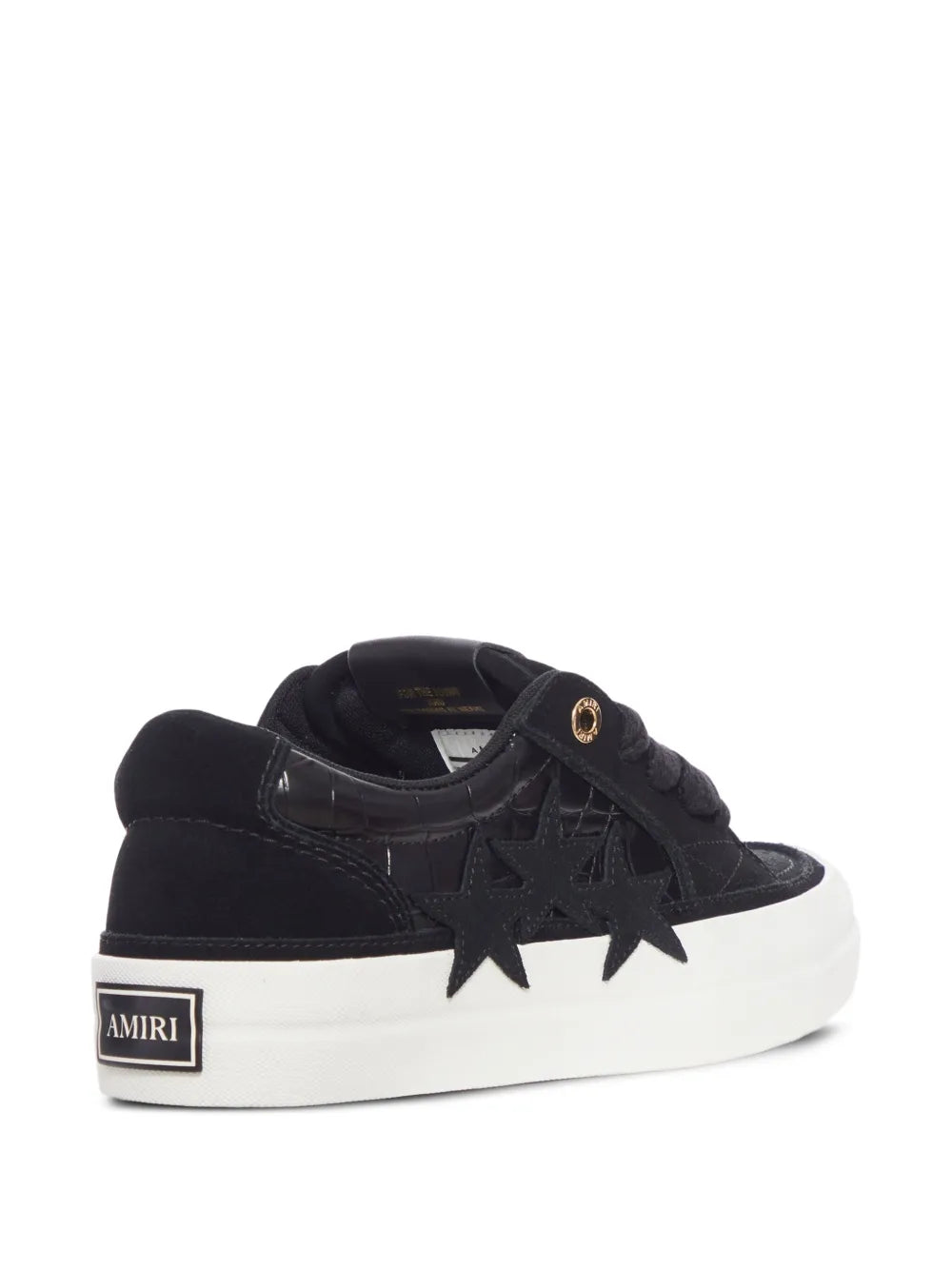 Black low-top sneakers with star applique detail, cushioned collar, and white rubber sole