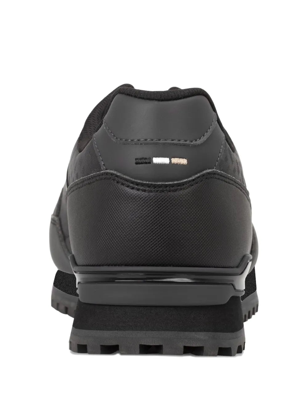 Black lace-up sneakers with padded collar, rear pull tab, and chunky tread sole
