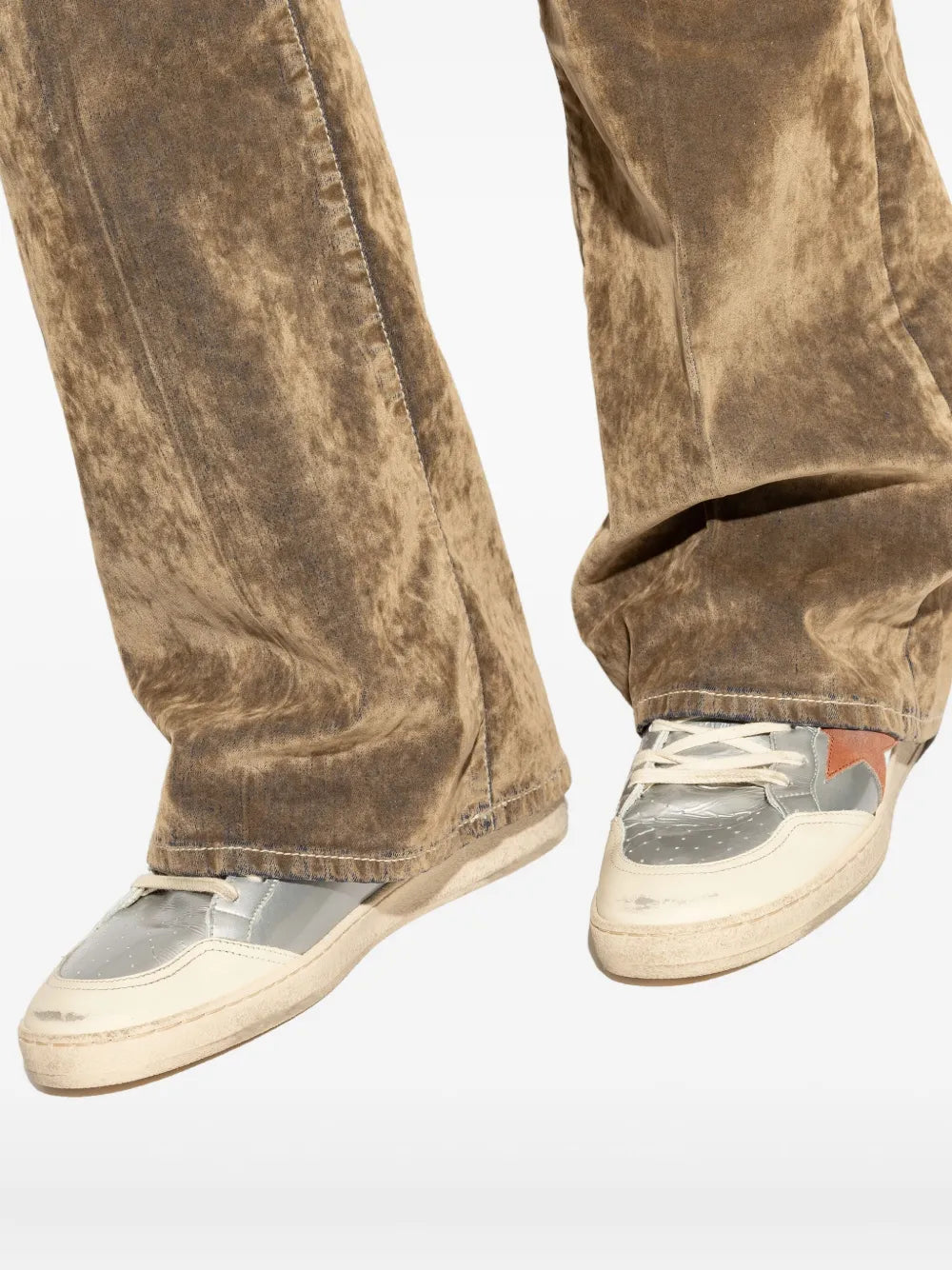 Ballstar sneakers worn with brown pants, white uppers and red side star