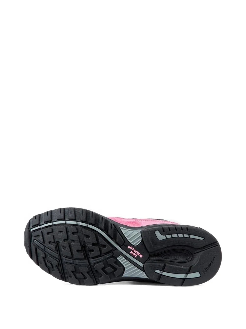 Black rubber outsole with traction tread on pink and gray New Balance sneakers