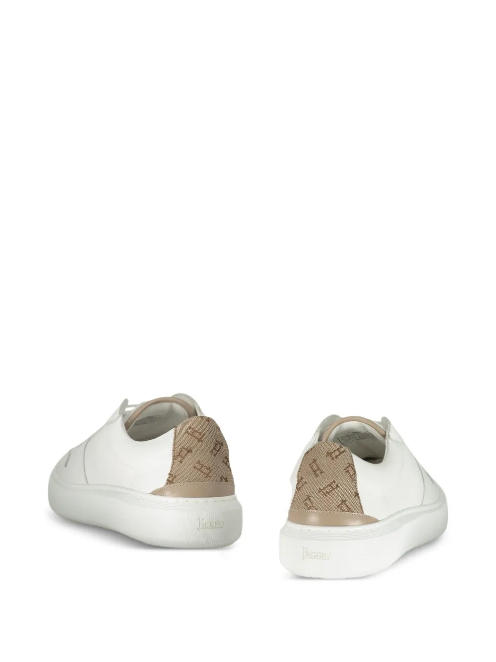 White leather-panelled low-top sneakers, back view with tan heel lining and pull tab