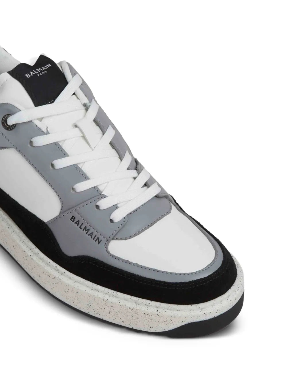Close-up of black, white and gray leather sneakers with laces, paneling and logo