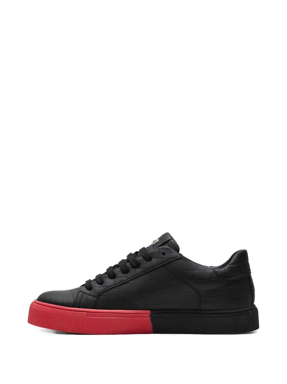 Black low-top sneakers with red outsole trim and stitched panel design