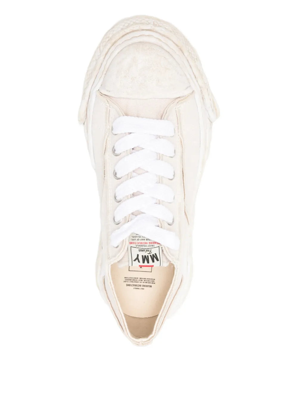 Beige sneaker interior view with lace-up upper and printed insole label