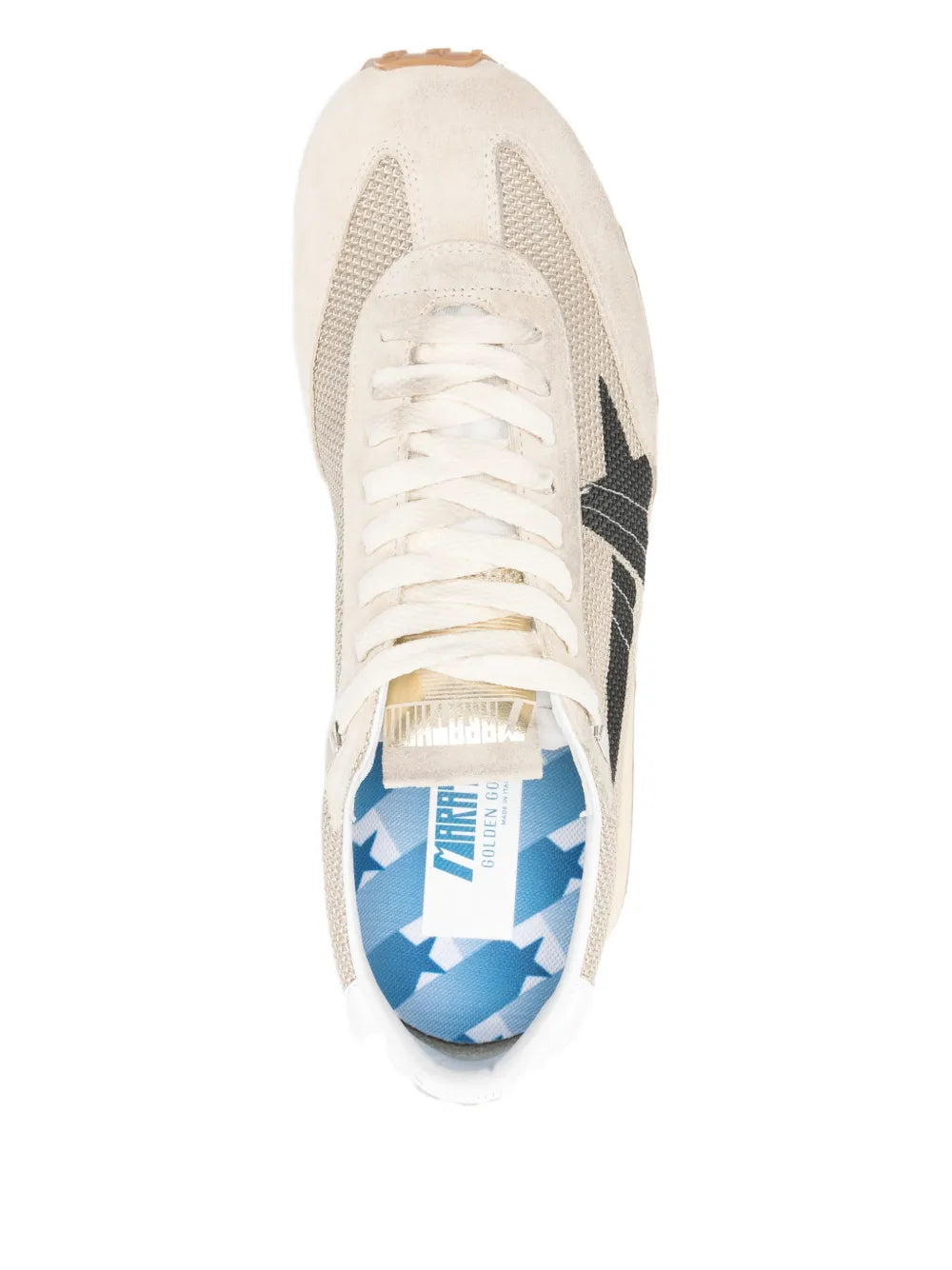 Beige sneaker side view with black star, white laces, and branded insole detail