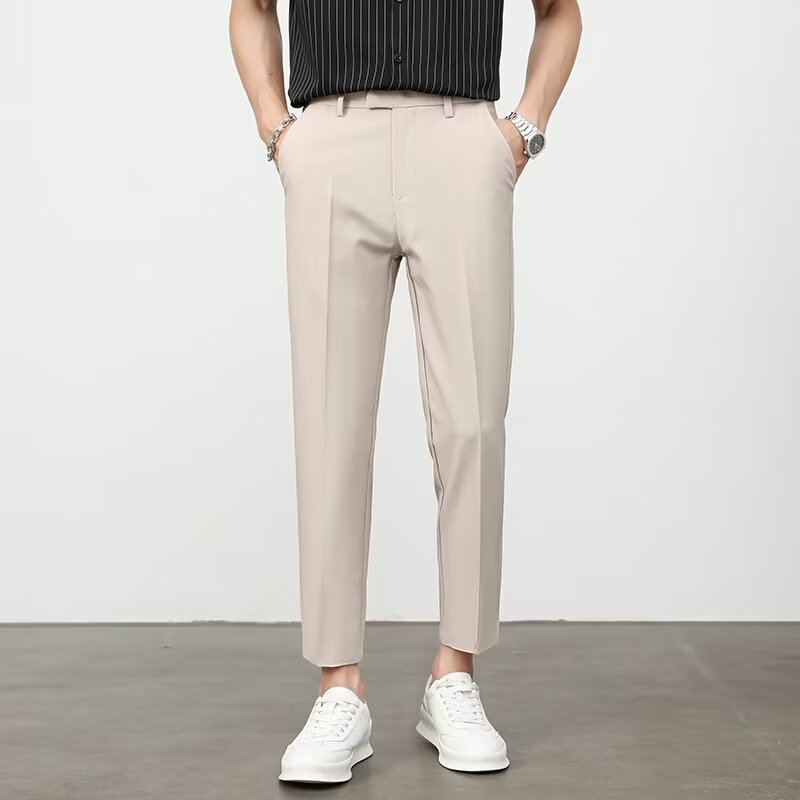 Men's dress pants in beige, flat front with belt loops and tapered ankle-length legs