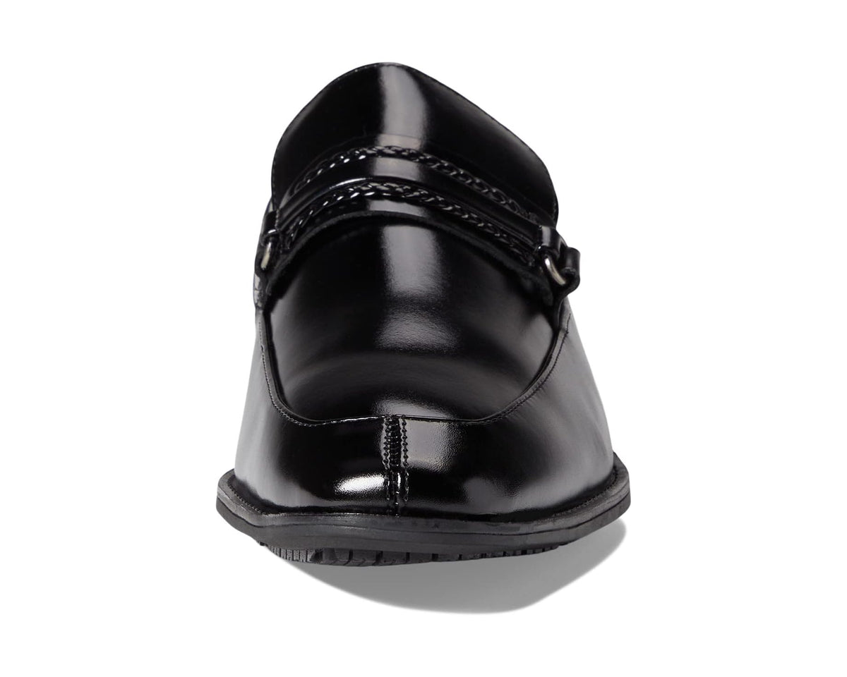 Black slip-on loafer rear view with buckle strap and glossy finish.