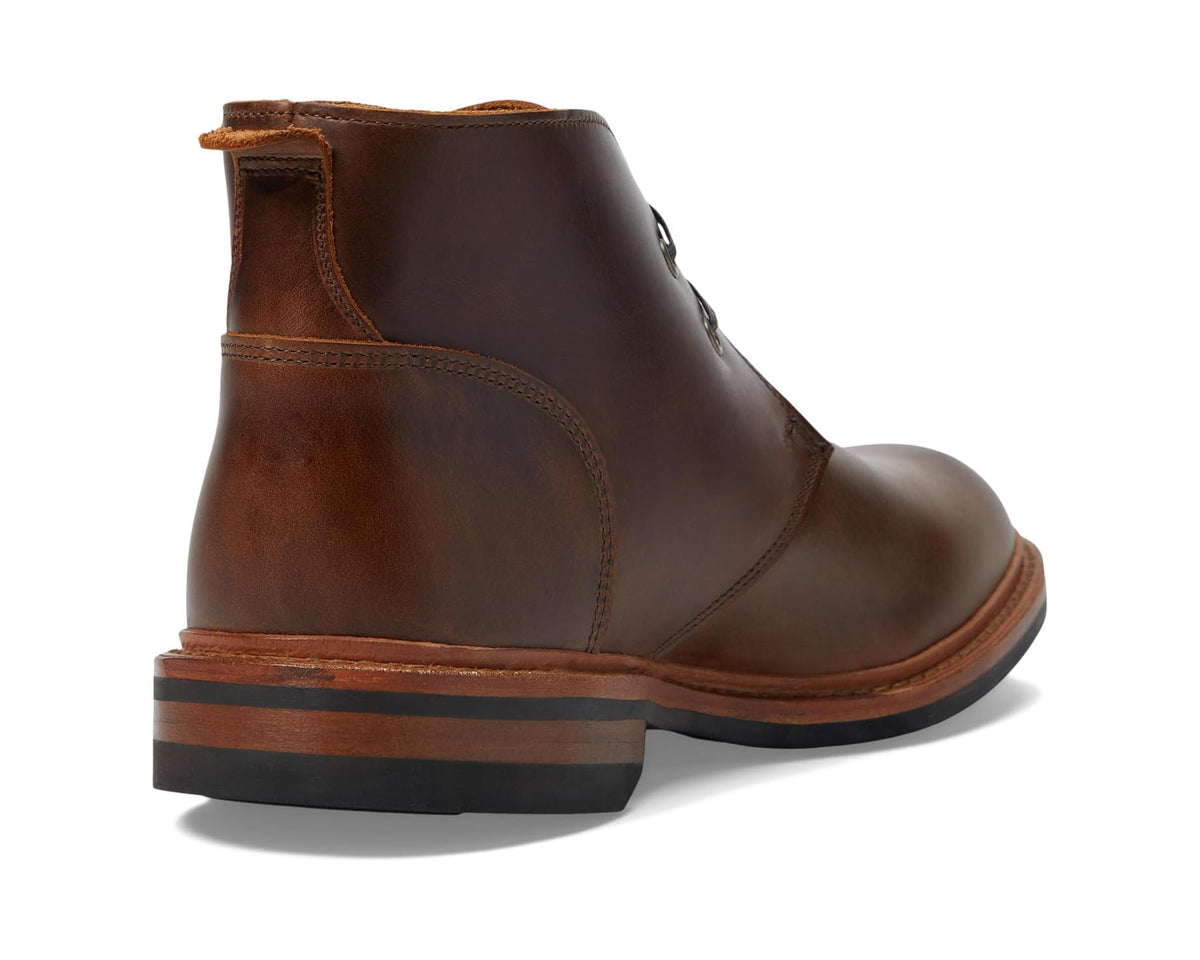Pecan-brown leather ankle boot heel side view with stitched panels and welt sole