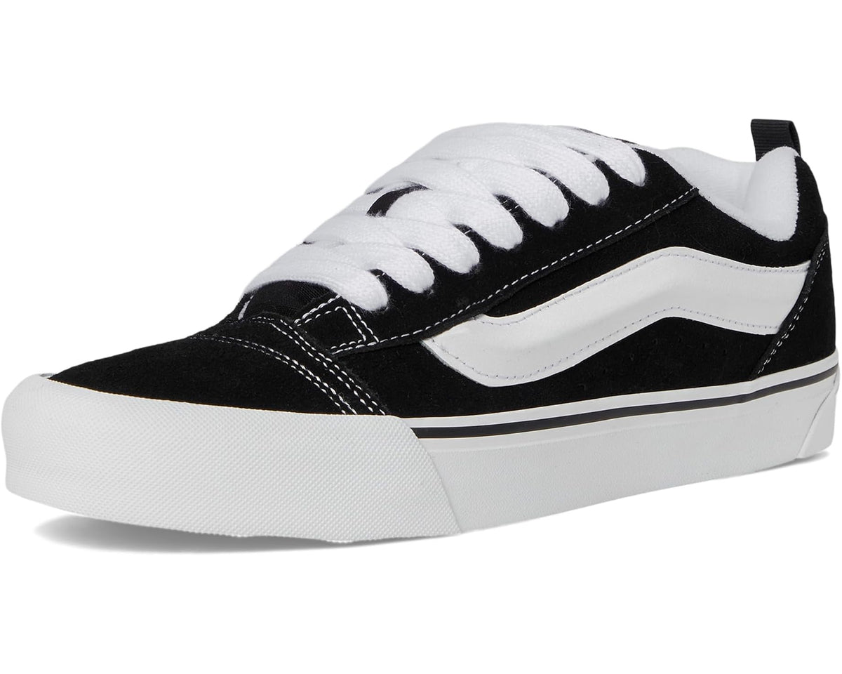 Black and white low-top lace-up sneakers with Vans side stripe and chunky sole