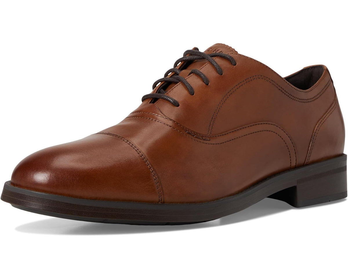 Men's leather cap-toe oxford shoes, 3/4 view, dark brown with tan paneling and laces.