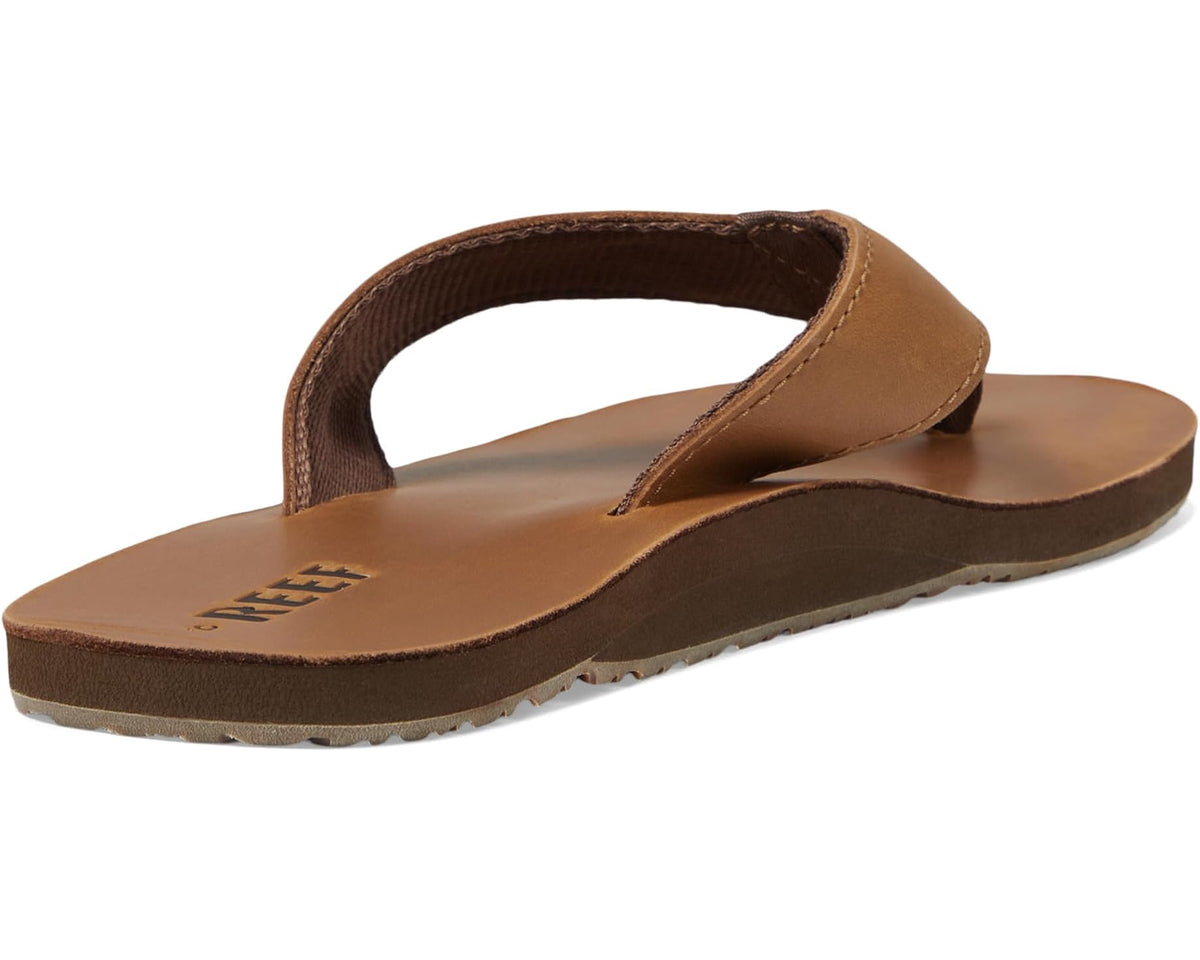 Bronze-brown Reef leather slide sandals with wide thong strap and cushioned sole.