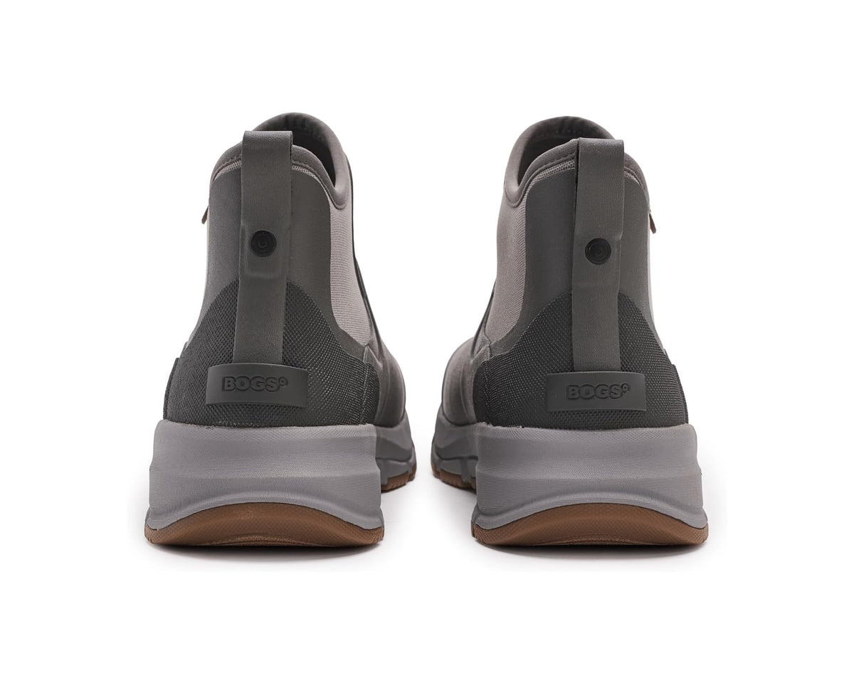 Gray chelsea boots with heel pull loops, elastic gore, and brown-lug rubber sole
