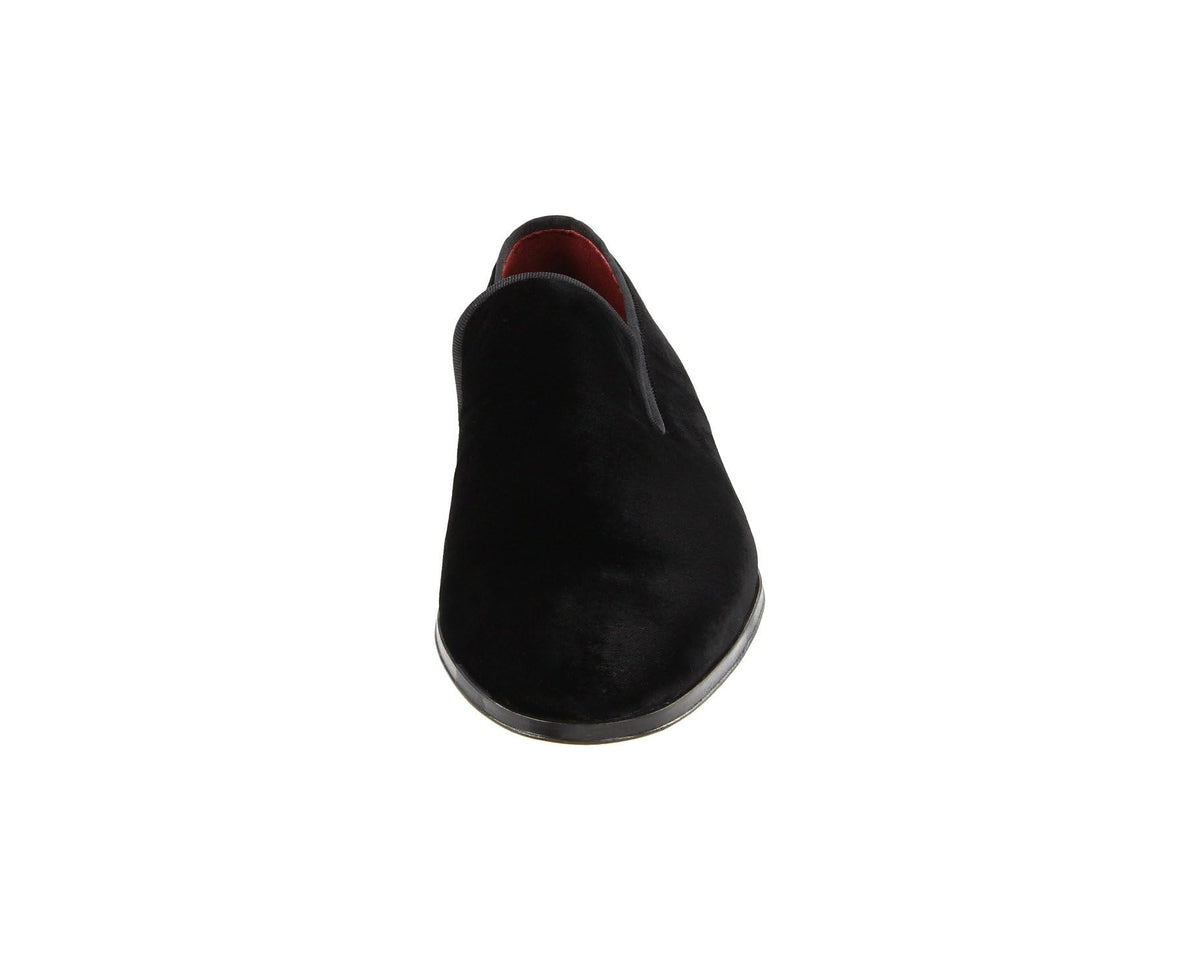 Black suede loafer front view with red-brown lining at collar