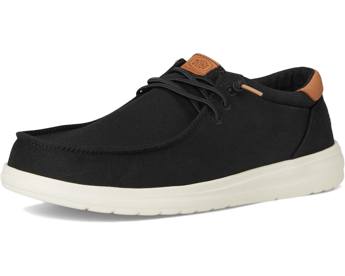 Black canvas lace-up shoe with tan heel accents and off-white rubber sole