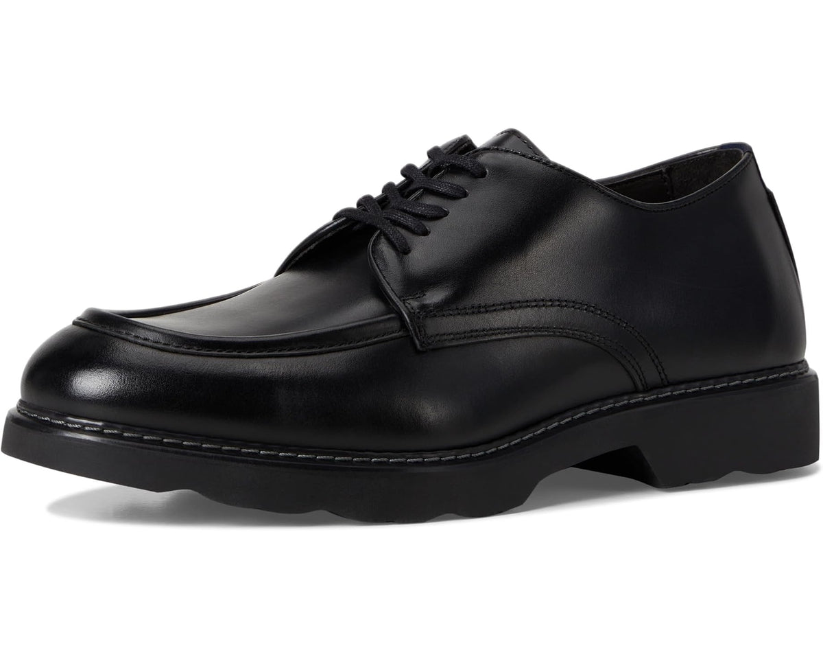 Black moc-toe lace-up derby shoe with rounded toe and rubber sole.