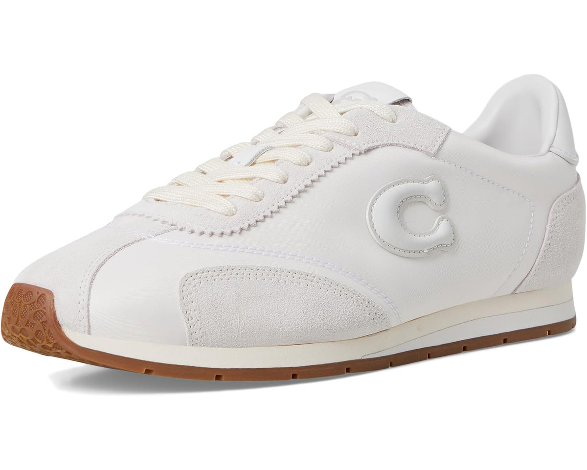COACH flat sneakers three-quarter view in optic white with tan rubber sole