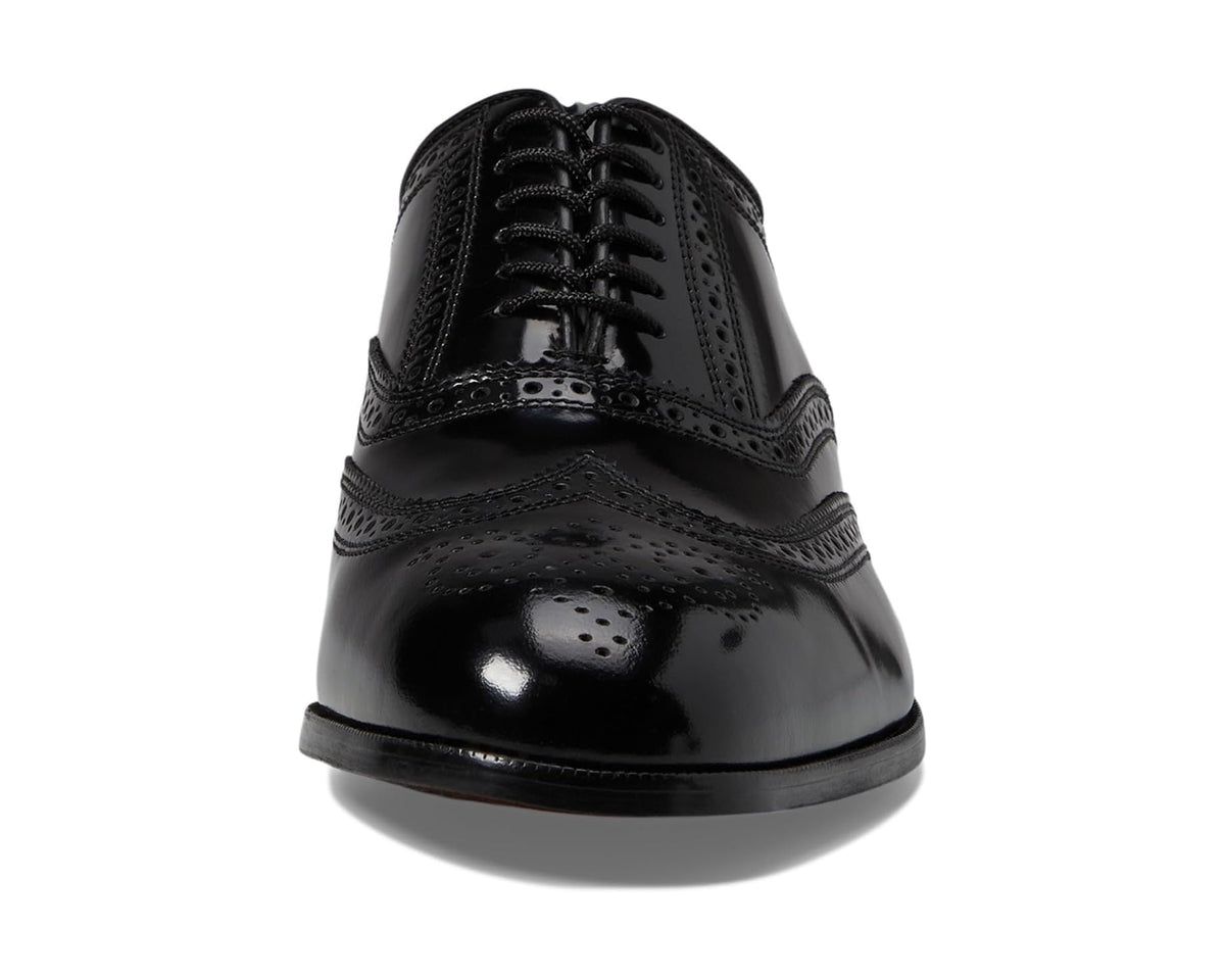 Men's black lace-up oxford with wingtip brogue and glossy cap-toe finish
