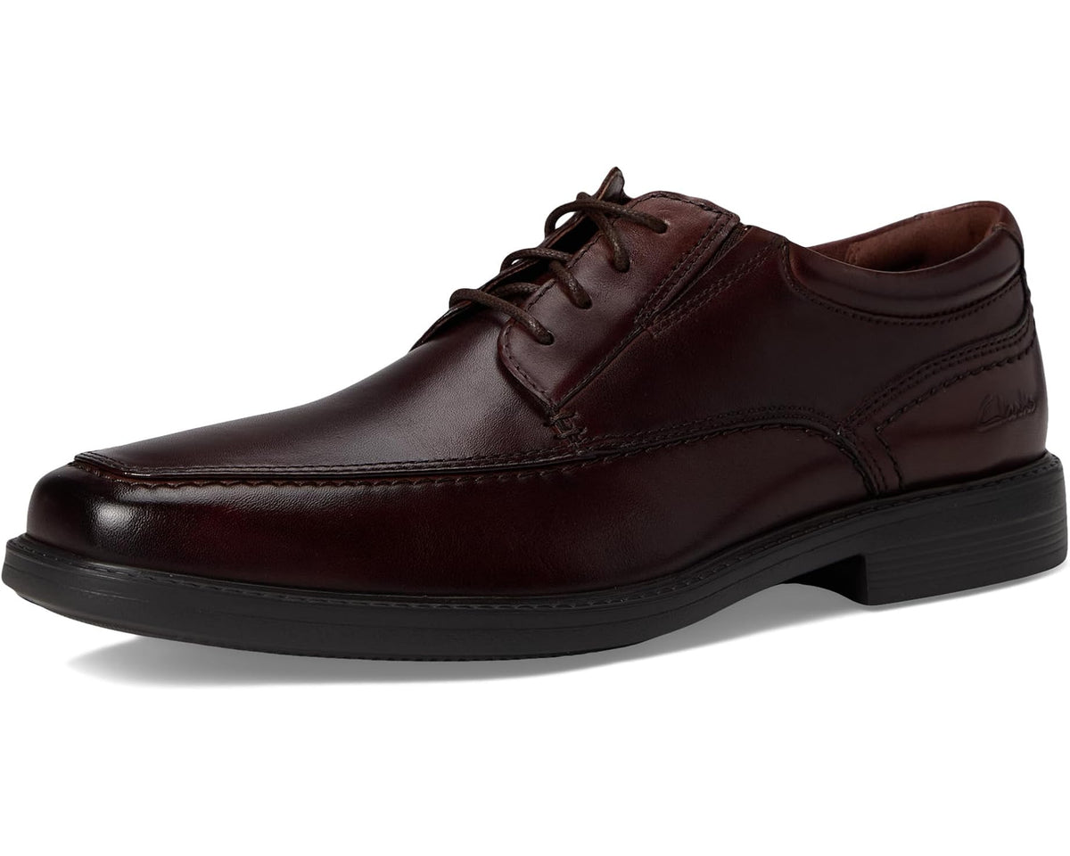 Mahogany leather lace-up dress shoe on white background with black sole and stitching